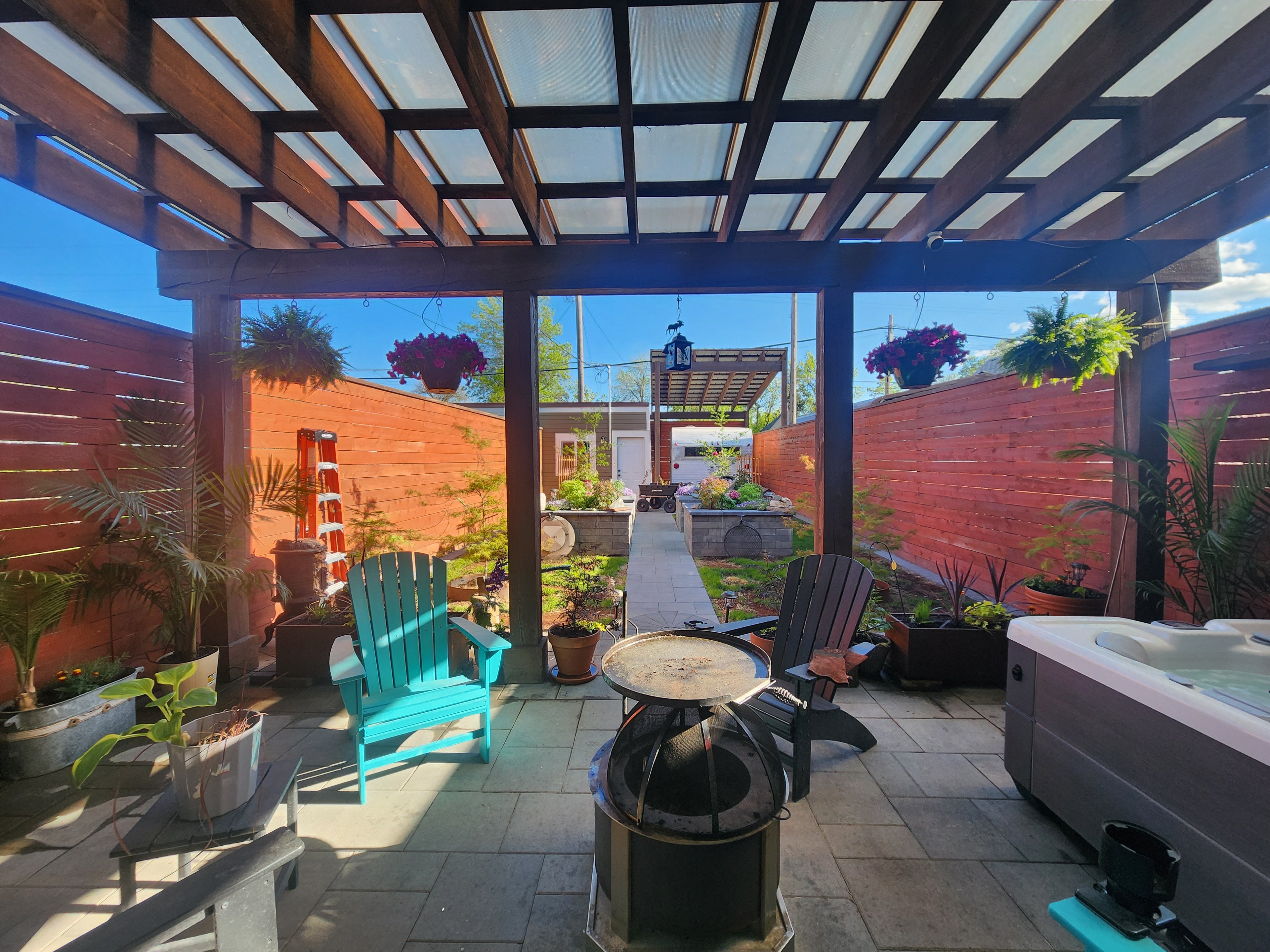 Backyard patio under a pergola with sky poly in Great Falls, MT