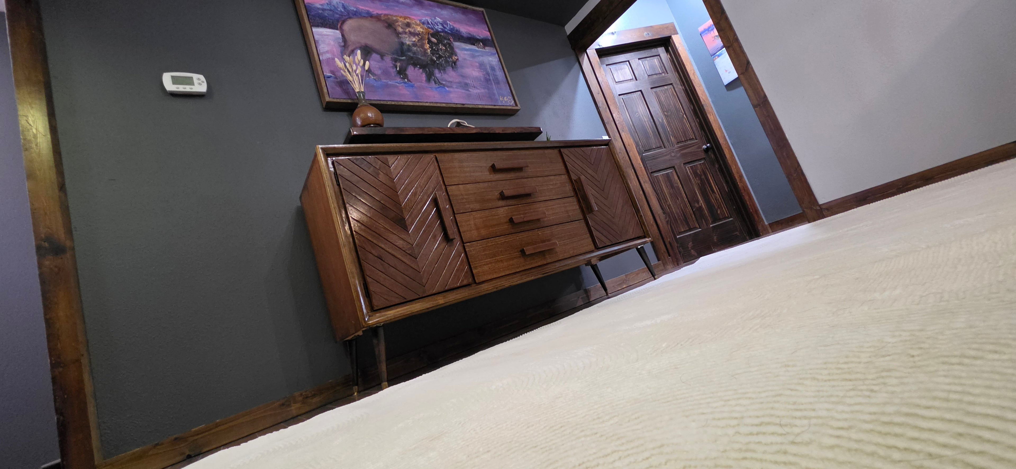 Custom walnut credenza with floathing shelf and buffalo painting