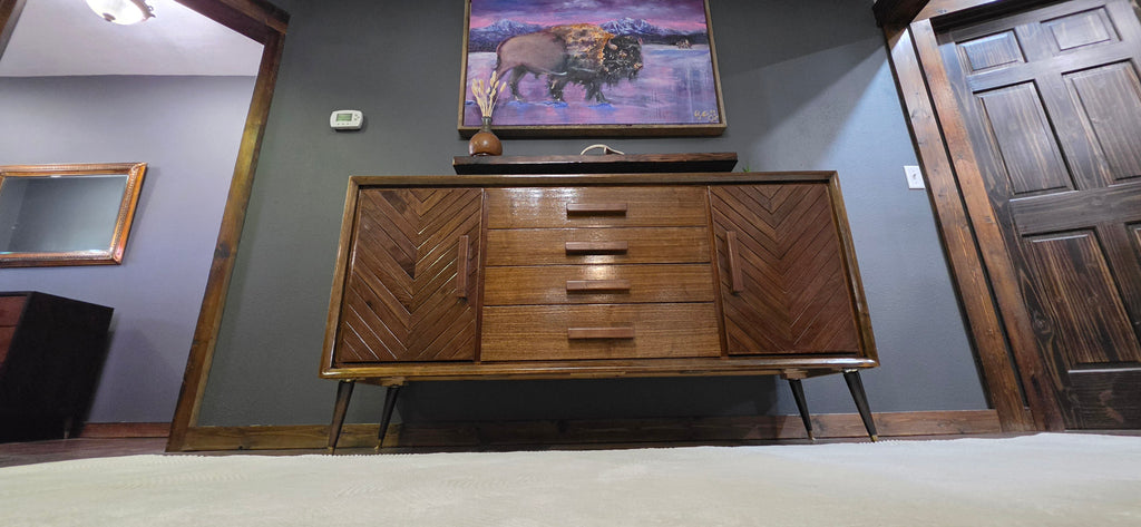Custom refinished walnut credenza with floating walnut shelf and buffalo painting